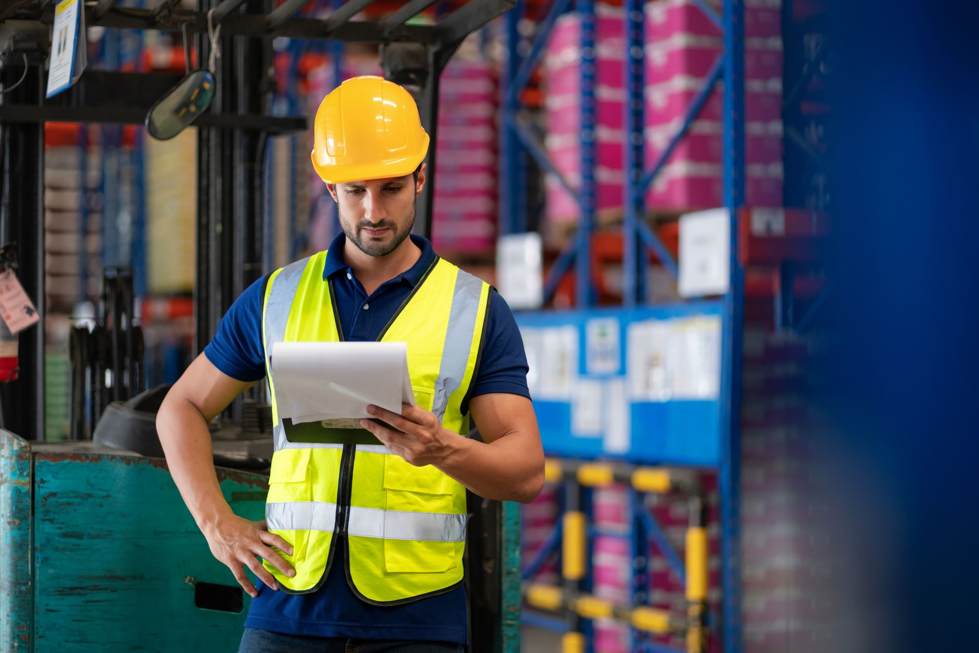 Warehouse auditor examining product quality on storage racks for quality control before customer delivery. Industrial logistics, inventory scrutiny, and supply chain efficiency in a distribution warehouse. Technology-driven business and global shipping so